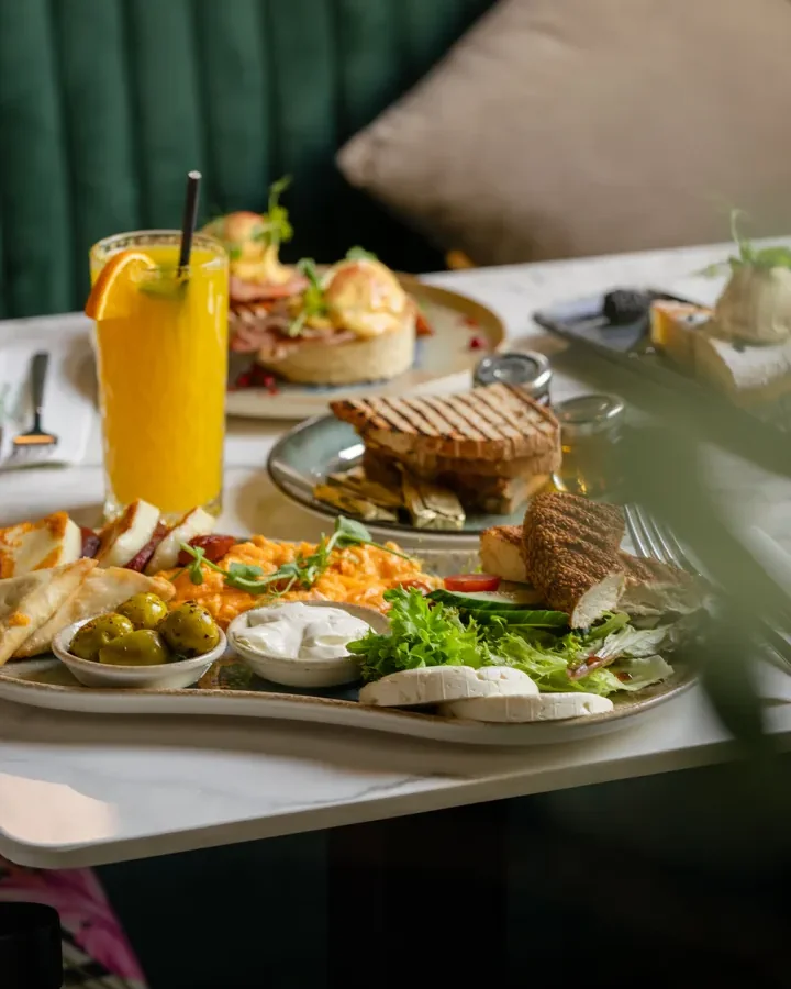 The Mediterranean breakfast — scrambled eggs, grilled halloumi, filo pastry, olives and feta — with fresh orange juice